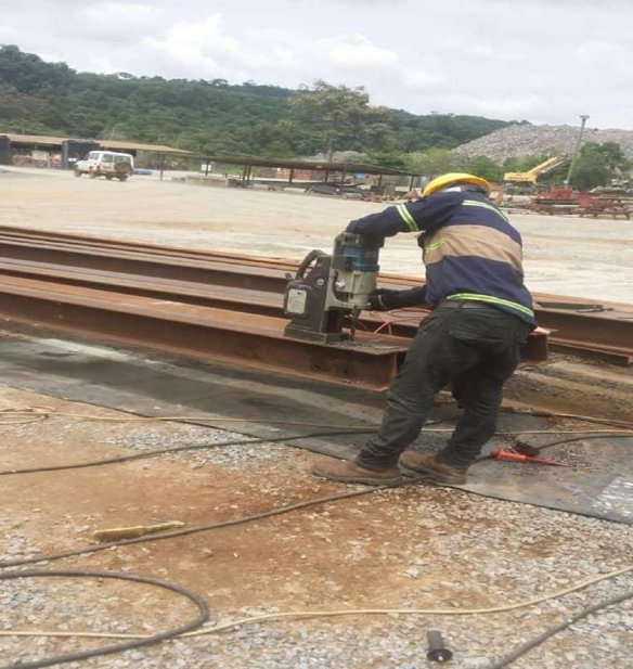 Worker grinding steel section